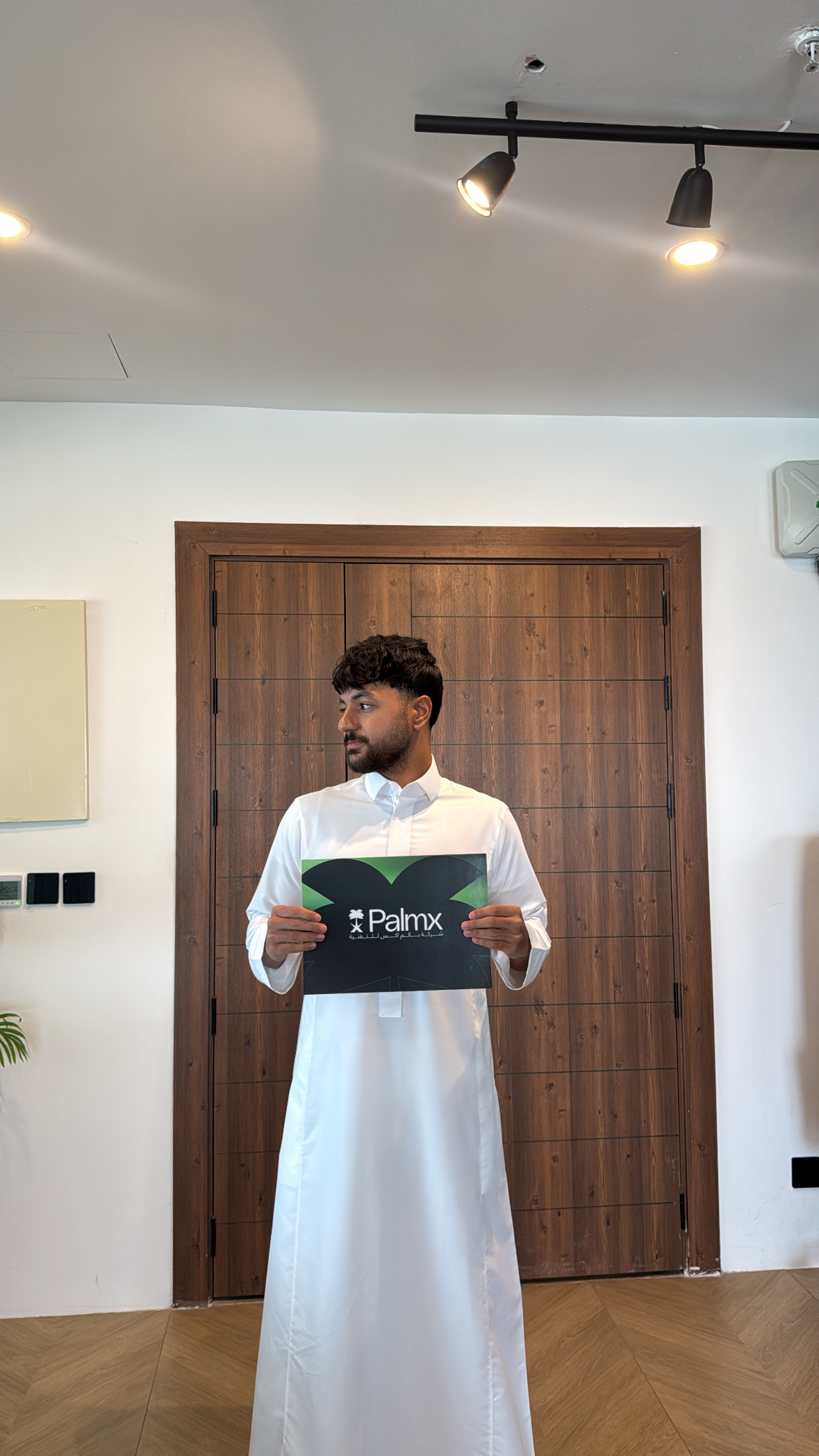 Fares Aldeeb holding a PalmX folder during his internship in Jeddah